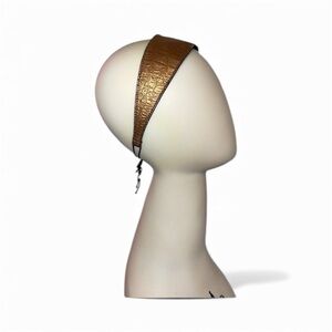 Hair band made of genuine leather elastic in the back . Metallic bronze / black